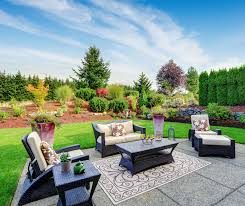 Garden patio seating area surrounded by planted borders